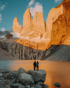 Pareja frente a amanecer en montañas de torres del paine